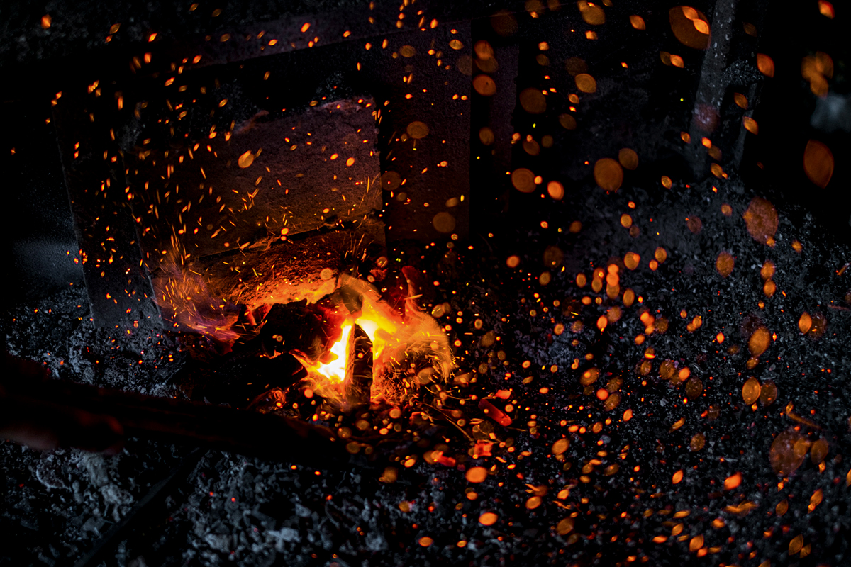 Peja/Peć, Kosovo. In a workshop of a blacksmith the fire is turned on for metalworking.