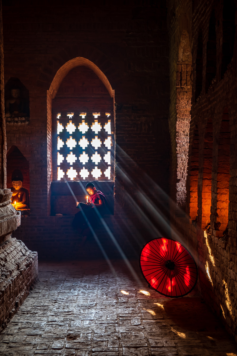 A novice reading a book in old temple