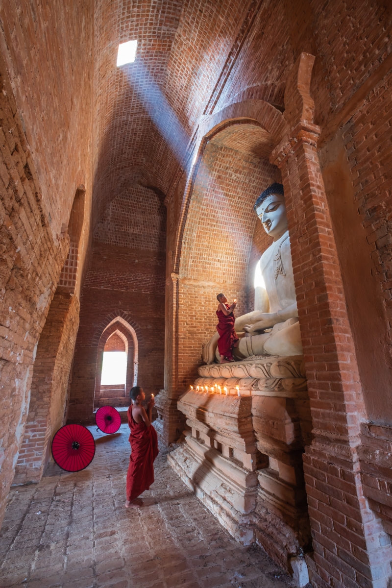 Novices praying with candle in Bagan