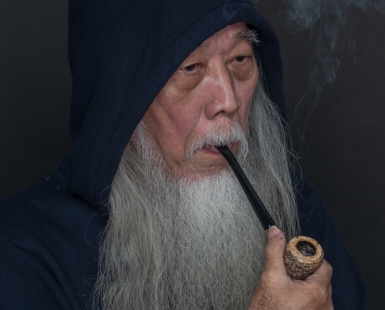 Man With A Long Beard Smoking A Pipe